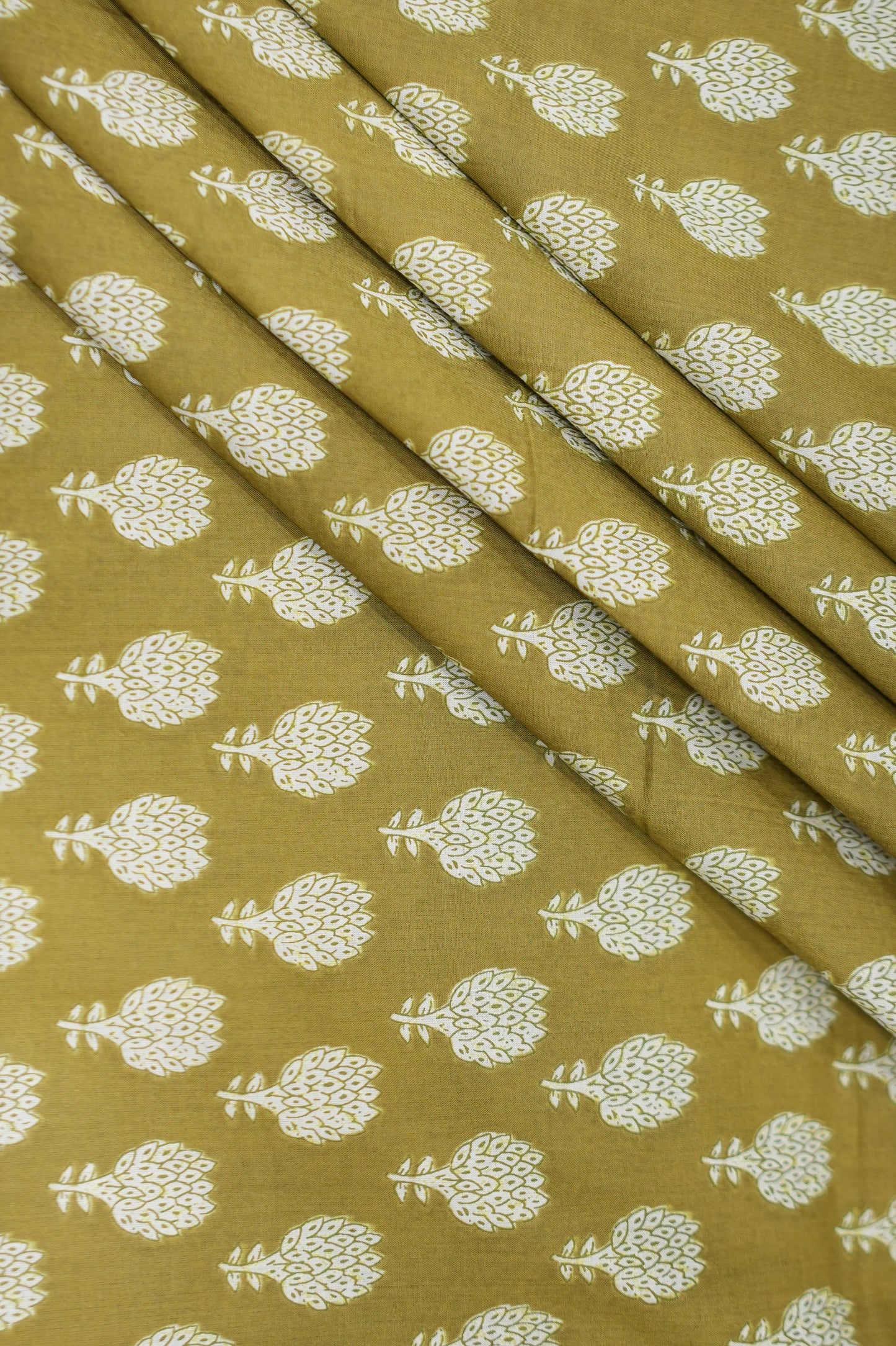 Fabric with white floral pattern on a mustard yellow background