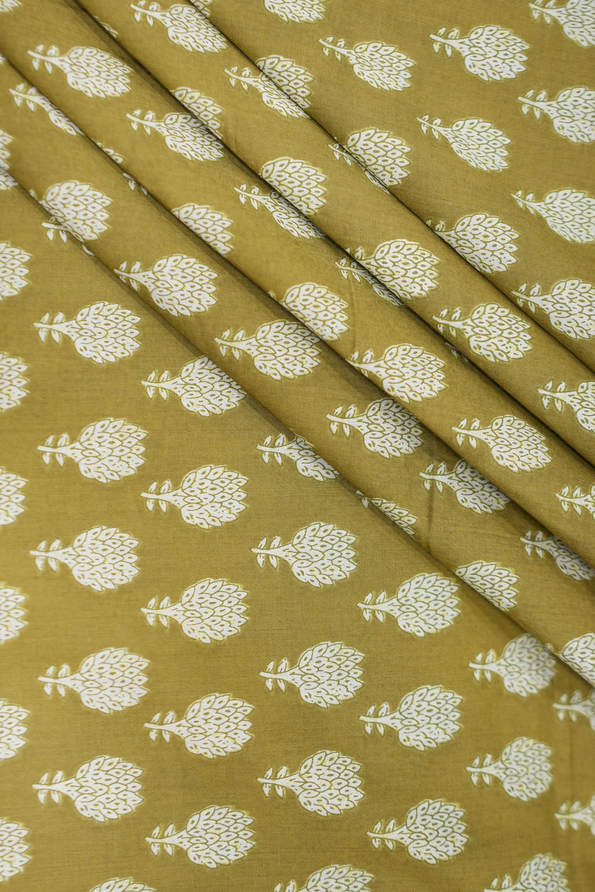 Fabric with white floral pattern on a mustard yellow background