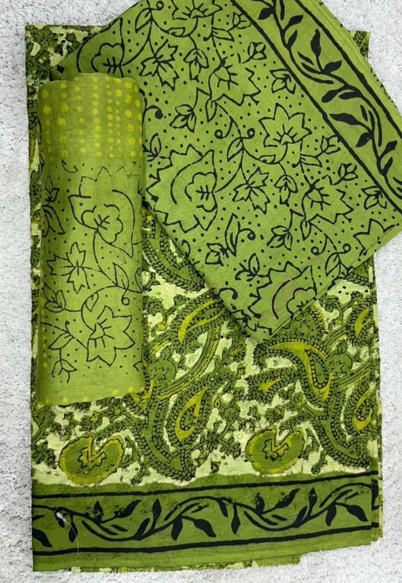 Green fabric with black paisley patterns on a textured surface