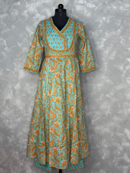 Long patterned dress on a mannequin against a textured gray background