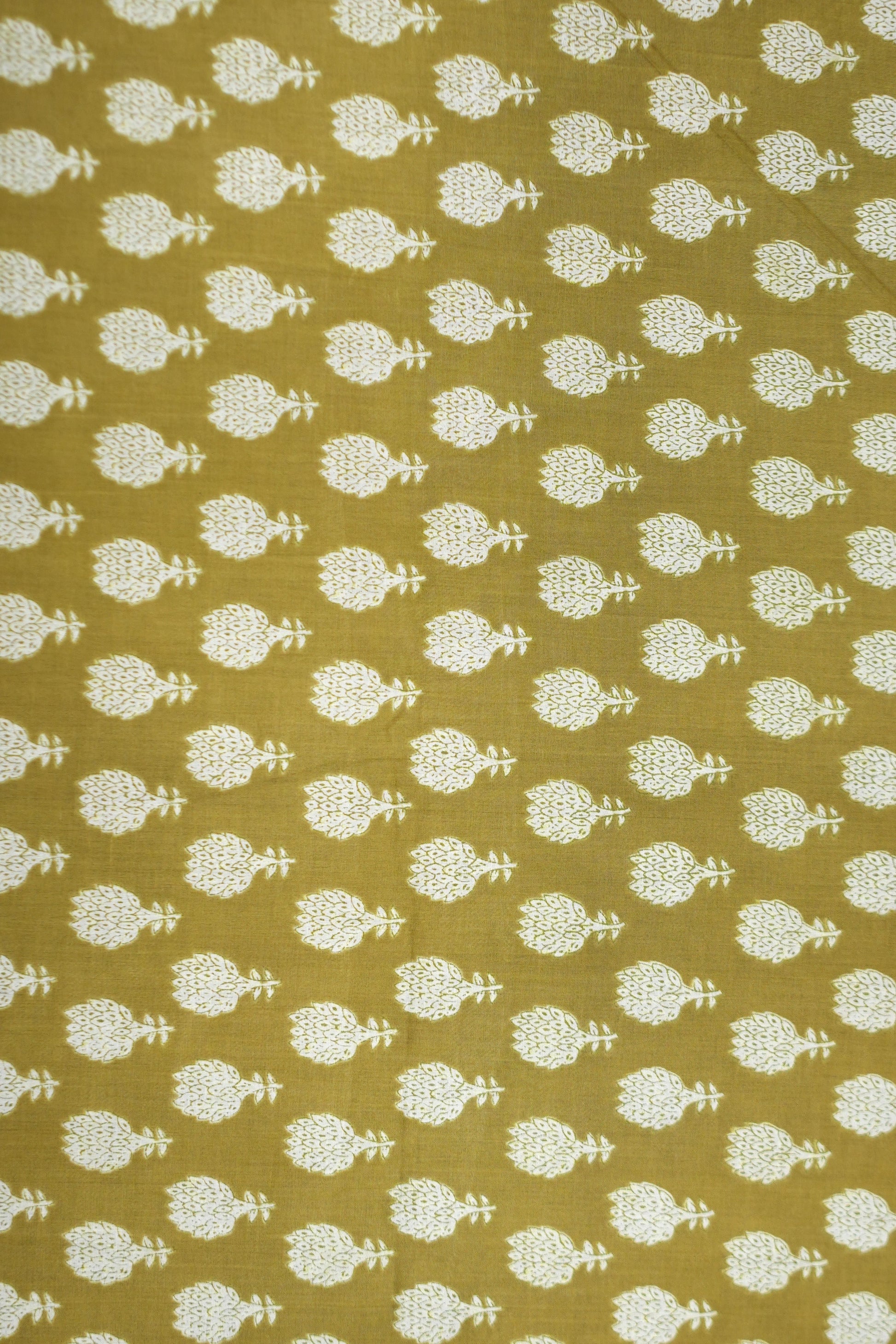 Patterned fabric with white floral design on a mustard yellow background
