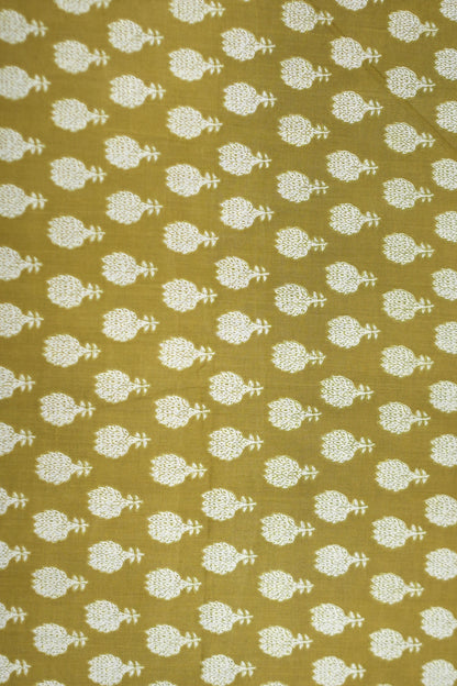 Patterned fabric with white floral design on a mustard yellow background