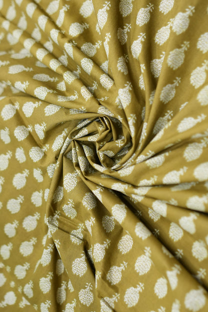 Roll of fabric with white floral pattern on a mustard yellow background