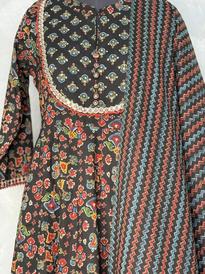 Traditional patterned garment with floral and zigzag designs on a white background