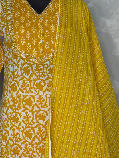 Yellow and white patterned fabric with intricate designs on a plain background