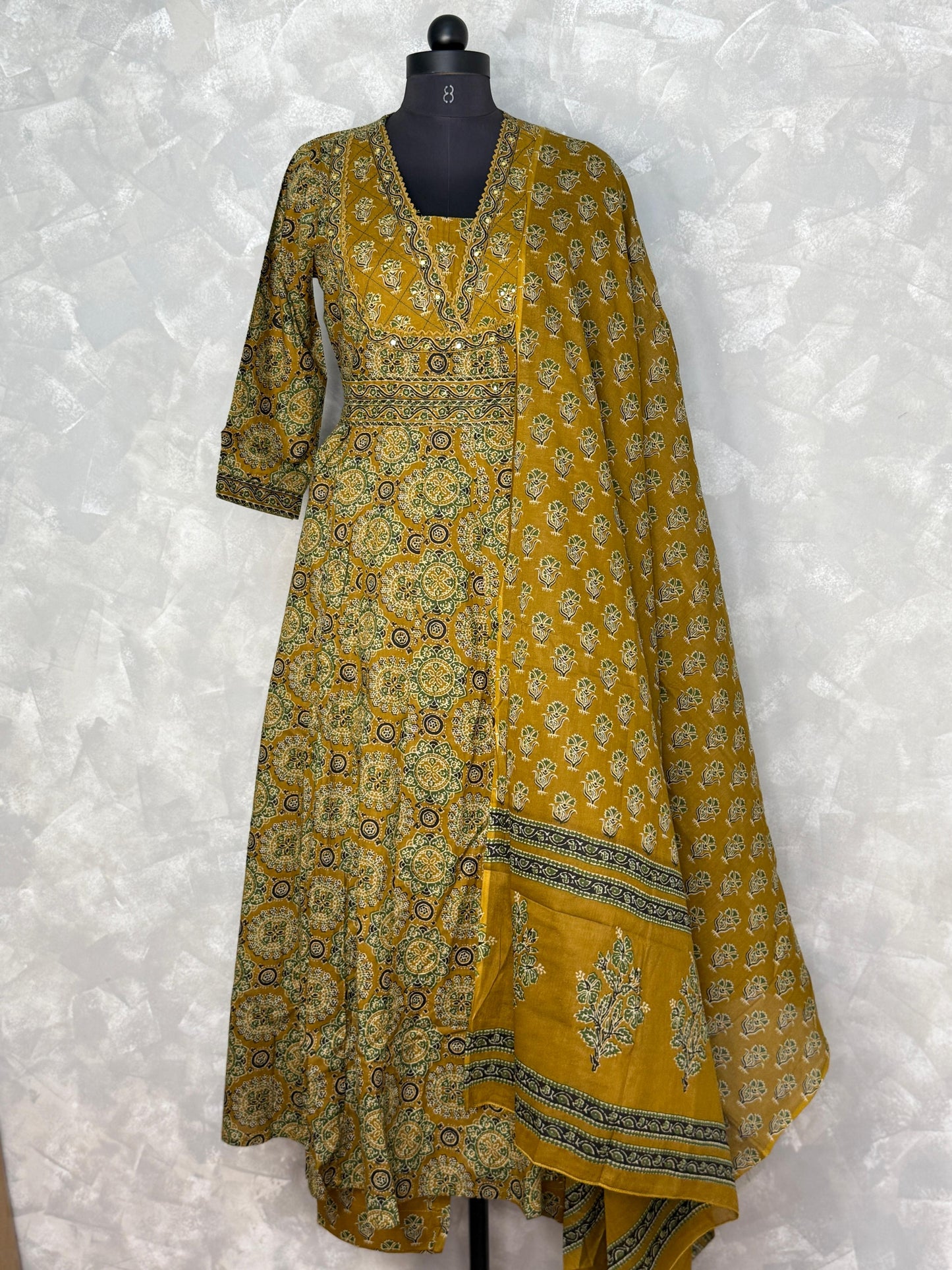 Yellow patterned dress with dupatta on a white background
