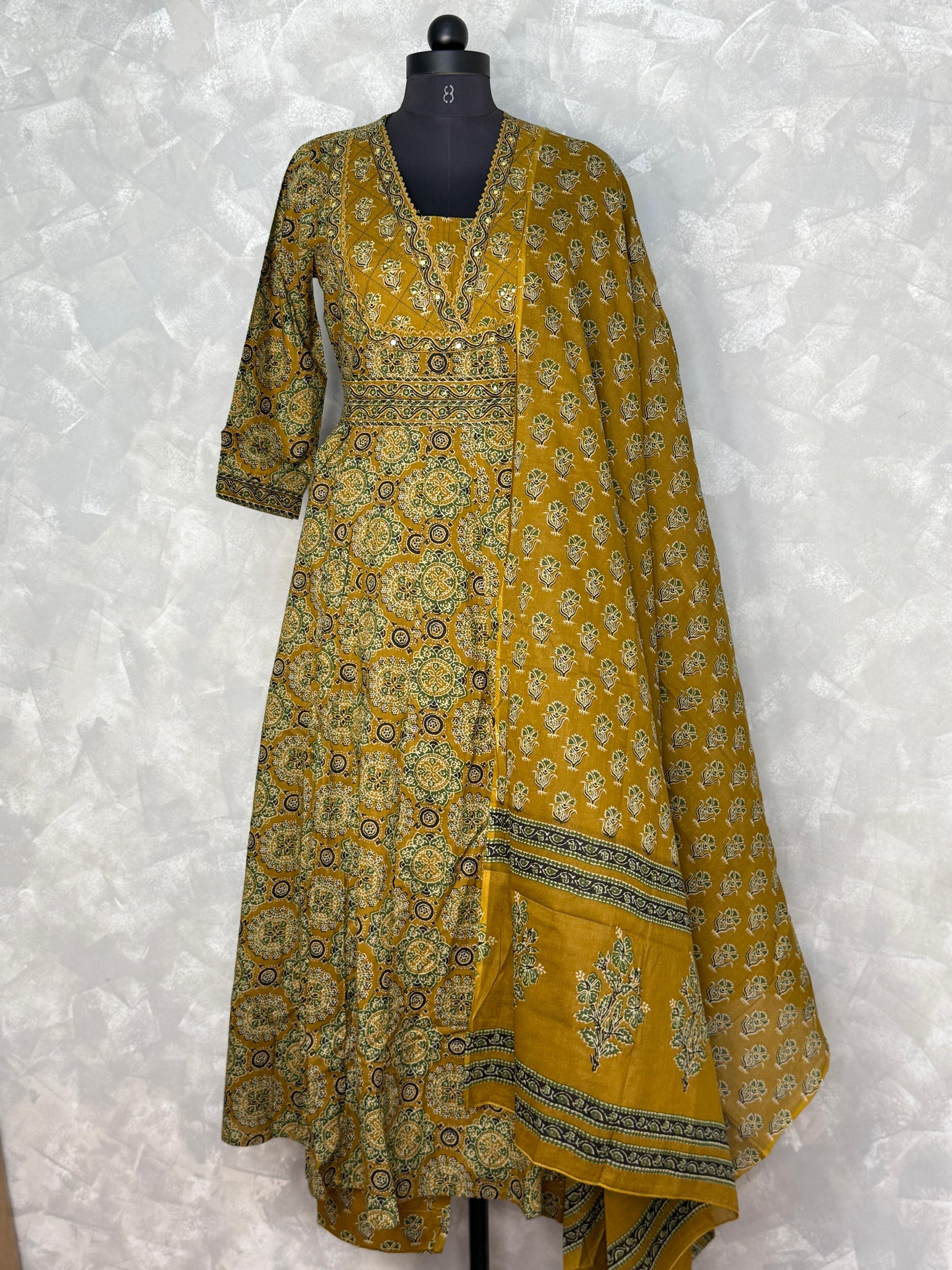 Yellow patterned dress with dupatta on a white background